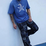 Last Lesson Blue Washed Star T-shirt worn by model with braided hair and patchwork jeans against white wall