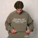 Natural Art Studio vintage wash green sweatshirt with faded logo and oversized fit