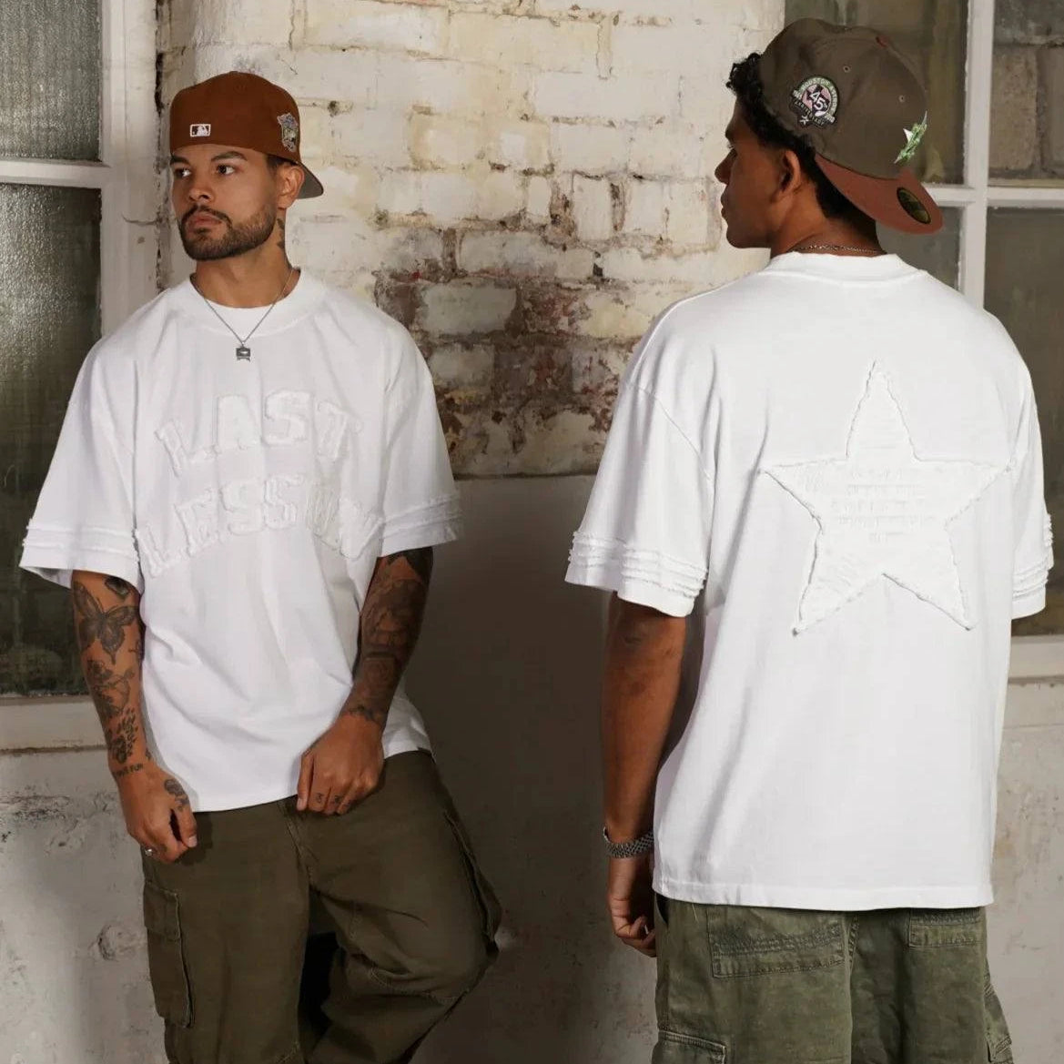 Last Lesson Appliqué white t-shirt with appliqué detailing and metal tag, styled with cargo pants.