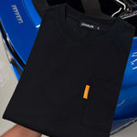 Studio By Charles black long sleeve tee with front pocket folded on blue car hood