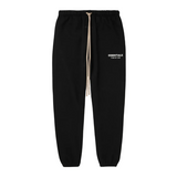 Black Fear of God Essentials fleece sweatpants with beige drawstring and logo print