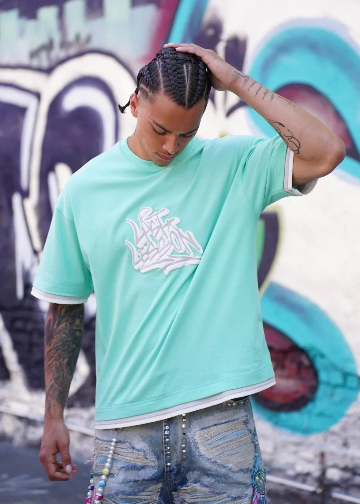 Last Lesson Graffiti 3 Layer T-Shirt with street art background.