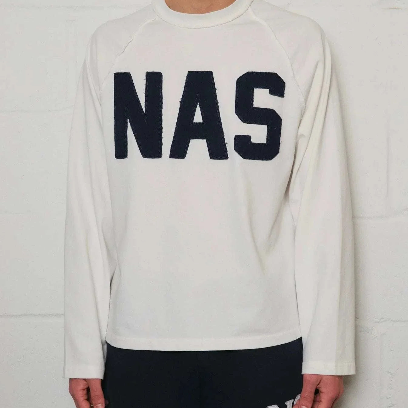 Natural Art Studio white cotton long sleeve sweatshirt with distressed NAS appliqué and boxy fit