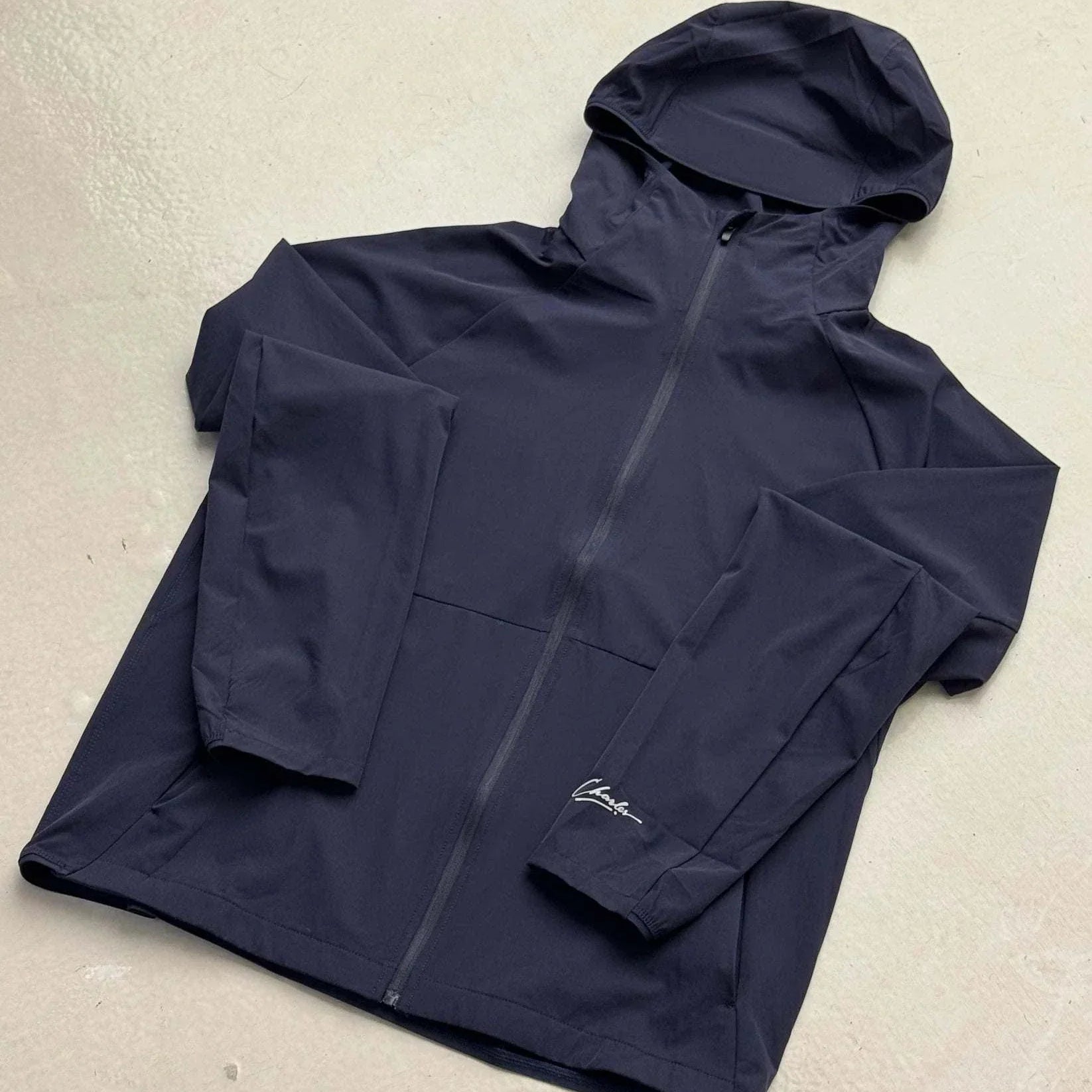 Studio By Charles navy blue hooded track jacket with front zipper and logo on sleeve