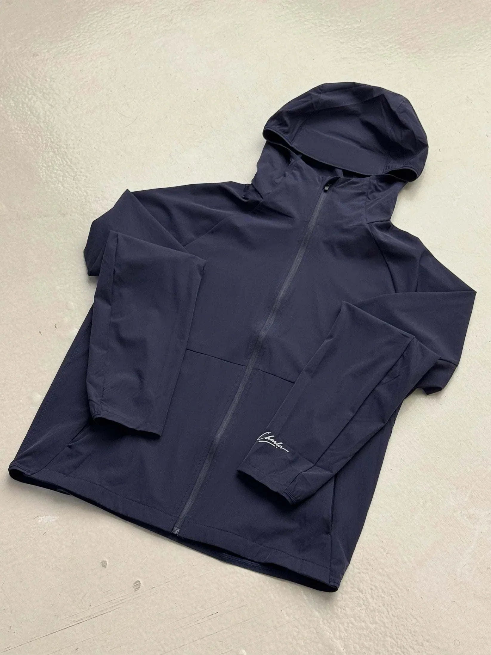 Studio By Charles navy blue hooded track jacket with front zipper and logo on sleeve