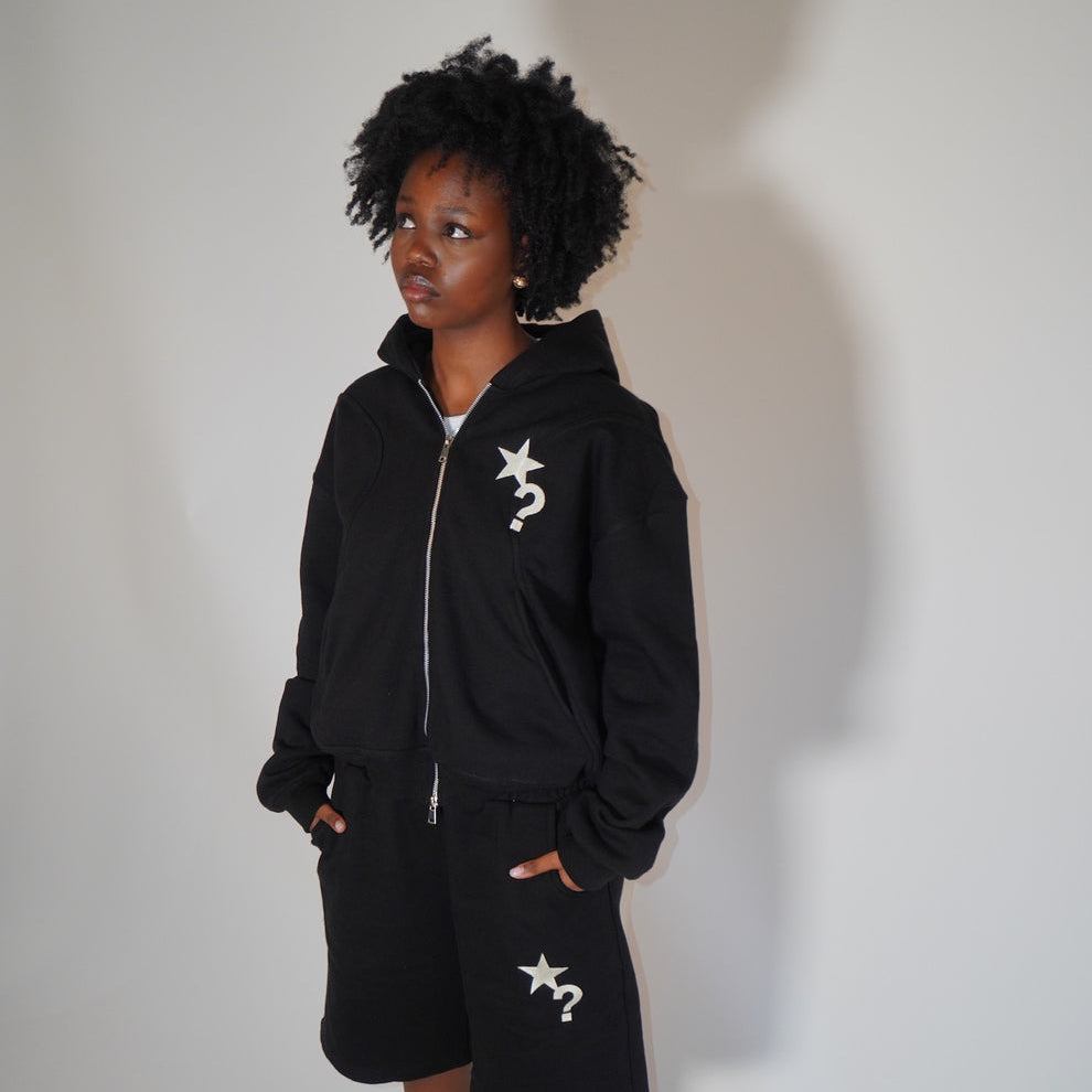Black Five Questions fleece zip-up hoodie with star and question mark design worn by model