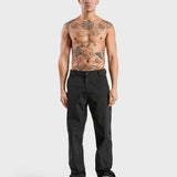 ANNIE HOOD Nylon Track Pants Black, wind and water-resistant with adjustable ankle pull cords, worn by model in size M.