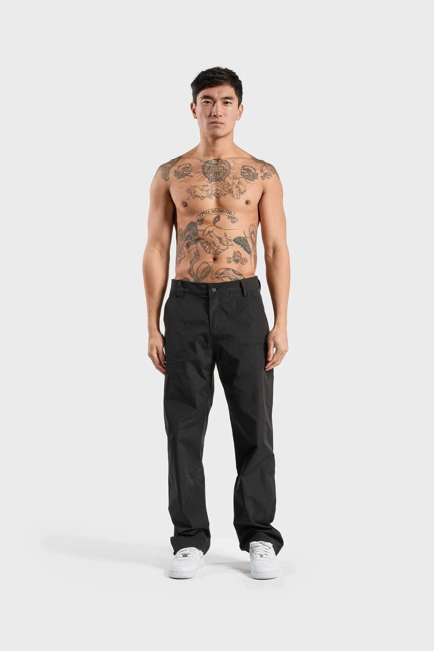 ANNIE HOOD Nylon Track Pants Black, wind and water-resistant with adjustable ankle pull cords, worn by model in size M.