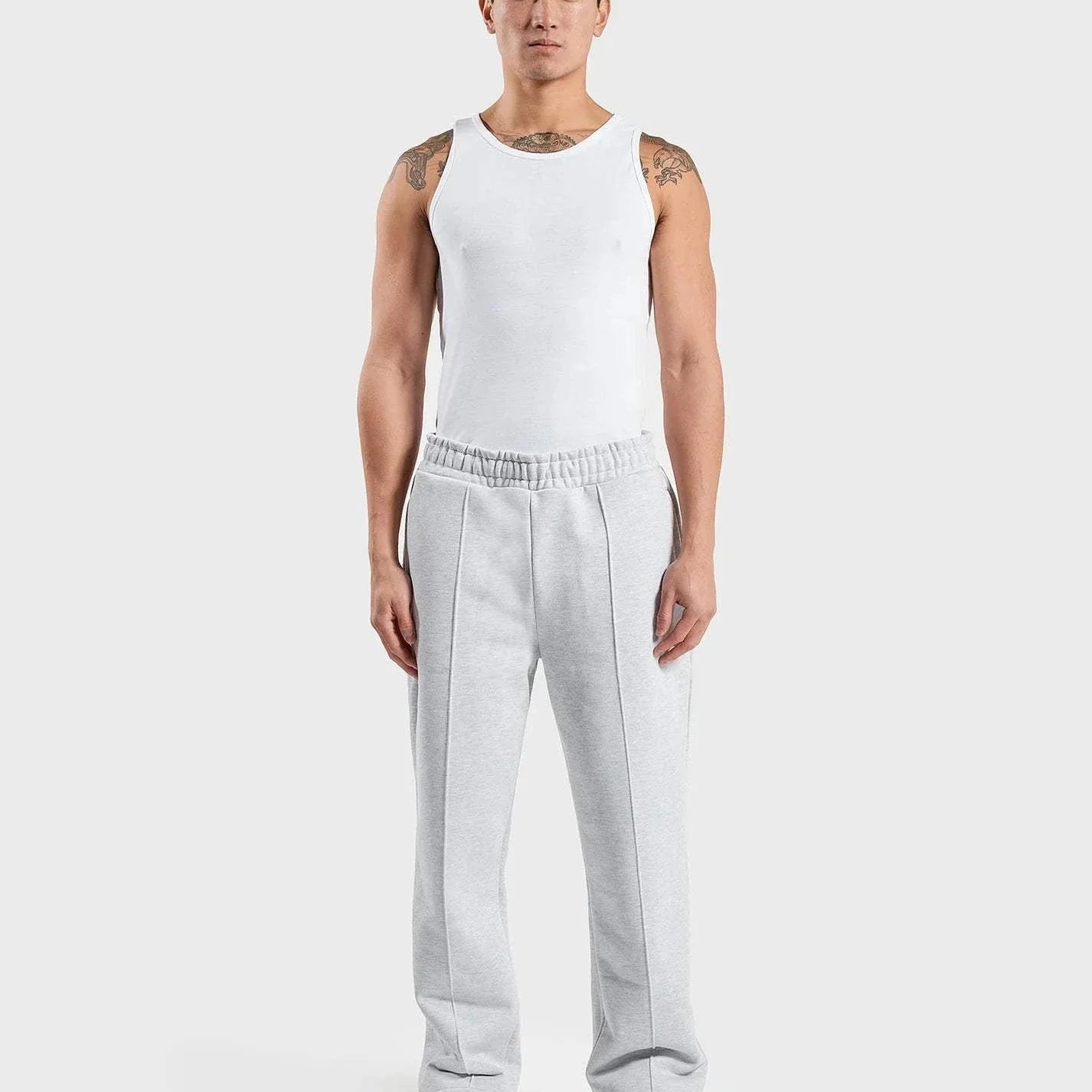 ANNIE HOOD grey straight-leg joggers on model, featuring front stitch line and embroidered back pocket logo.