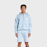 Man wearing baby blue ANNIE HOOD College zip hoodie with dropped shoulder and boxy shape, featuring double embroidery logo and matching shorts
