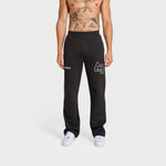 Male model wearing black ANNIE HOOD College joggers with white sneakers on white background