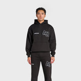 Black ANNIE HOOD College Hoody with dropped shoulder, boxy fit, and double embroidery logo worn by male model