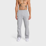 Male model wearing grey ANNIE HOOD College Joggers with white sneakers on plain background