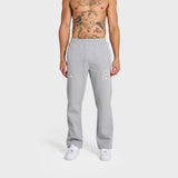 Male model wearing grey ANNIE HOOD College Joggers with white sneakers on plain background