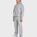 Man wearing ANNIE HOOD College Hoody grey oversized fit with matching sweatpants and white sneakers