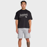 Man wearing black ANNIE HOOD Baseball T-shirt and gray shorts