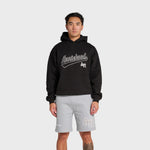 Man wearing black ANNIE HOOD Baseball Hoody with dropped shoulder and double embroidery logo