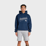 Man wearing navy ANNIE HOOD Baseball Hoody with dropped shoulder and double embroidery logo