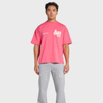 Man wearing pink ANNIE HOOD College T-shirt and gray sweatpants with logo