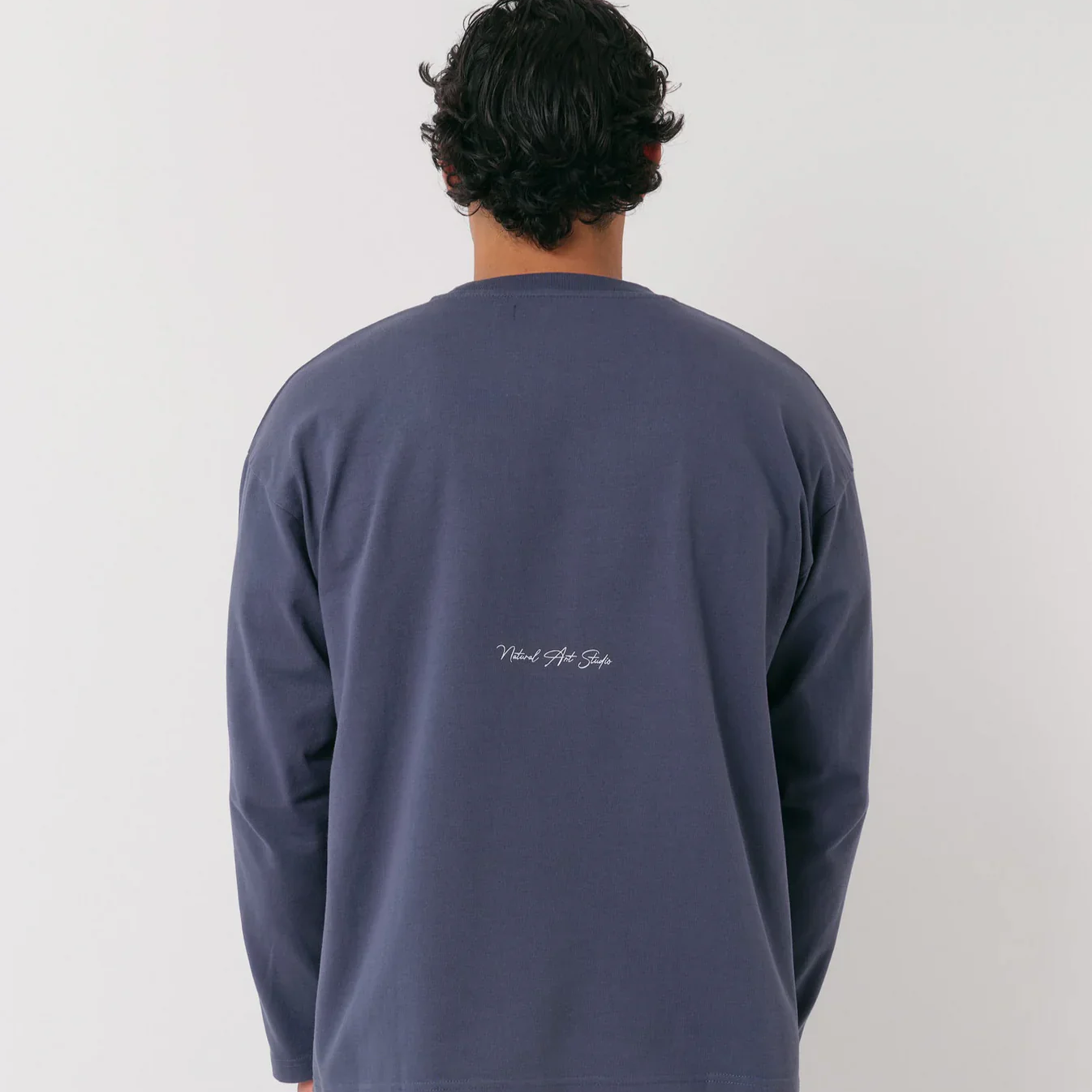 Navy long-sleeve shirt with distressed front logo and screen print back by Natural Art Studio.