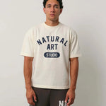 Natural Art Studio Varsity Tee with navy screen print on front, boxy fit, oversized drop shoulder, 100% cotton, worn by male model