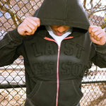 Last Lesson Appliqué Black Hoodie worn by a model outdoors.