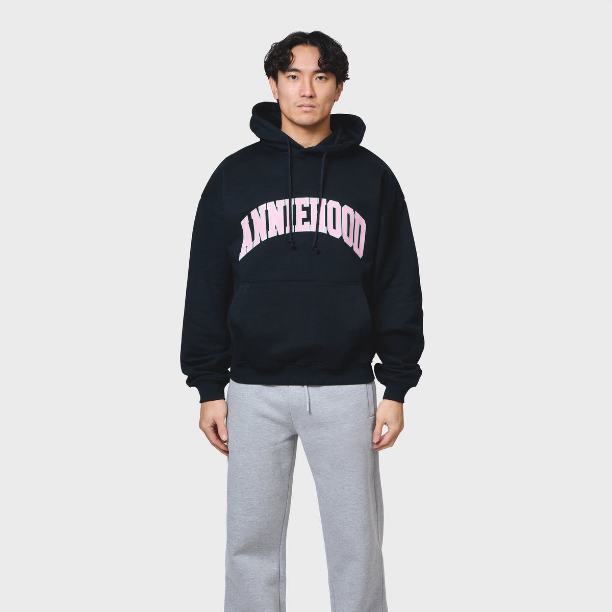 Navy ANNIE HOOD COLLEGE arch hoody in 500gsm brushback cotton with relaxed fit modeled by tall man