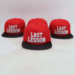 Red Last Lesson SnapBack Hat with black brim and white embroidered text