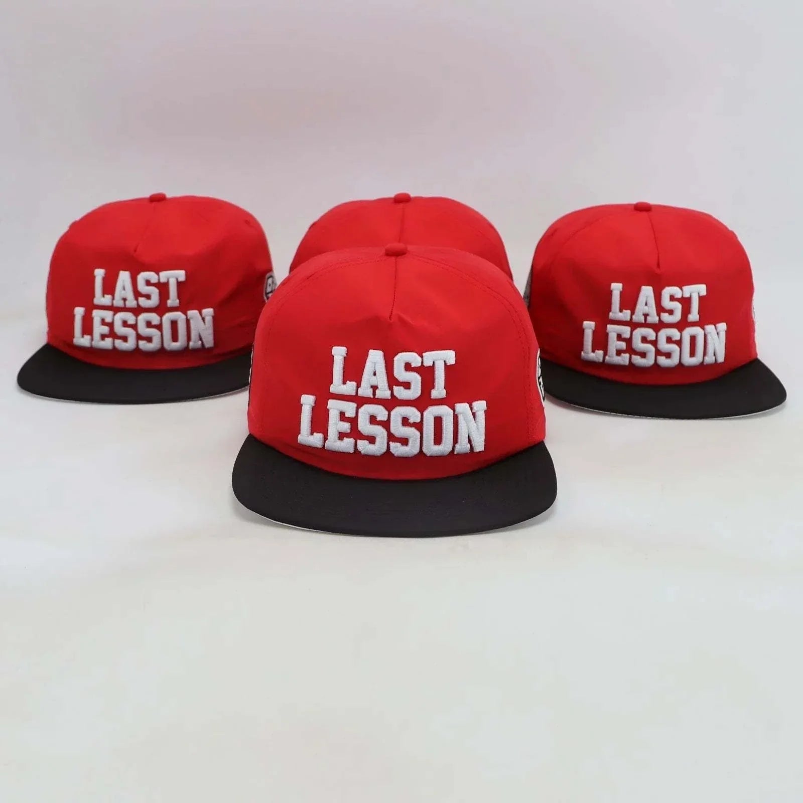 Red Last Lesson SnapBack Hat with black brim and white embroidered text