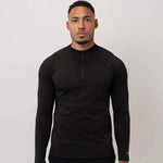 Cova Daily black quarter zip long sleeve top worn by male model