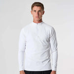 Male model wearing white Cova Daily Quarter Zip with long sleeves and front zipper