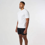 Man wearing white Cova Daily T-Shirt with black shorts against white background