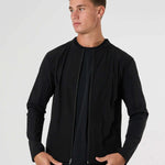 Man wearing black Cova Daily Track Jacket with front zipper and long sleeves against white background