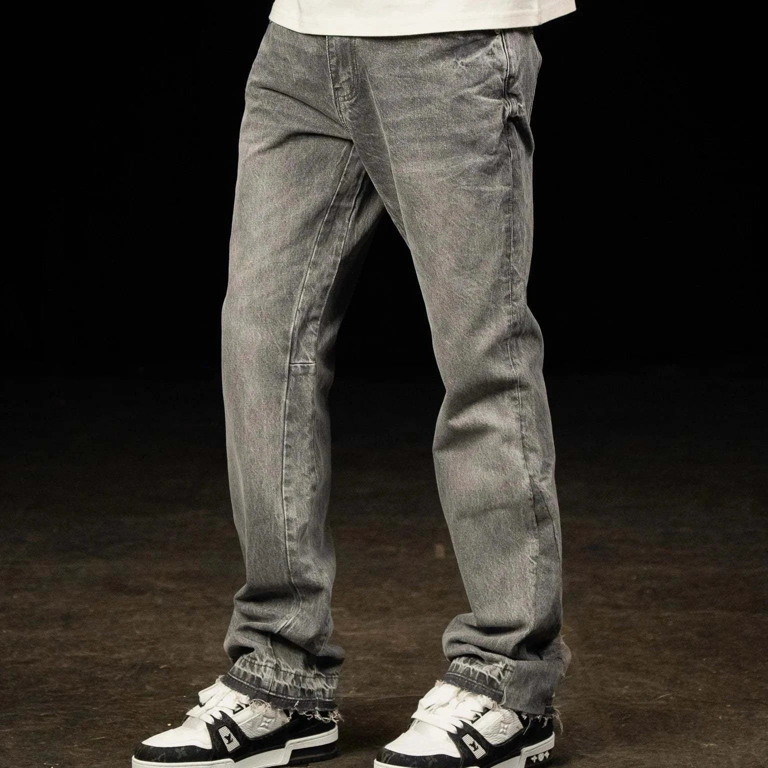 Siarr Flared Jeans Triple Grey with open hem and branded rivet buttons on model