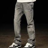 Siarr Flared Jeans Triple Grey with open hem and branded rivet buttons on model