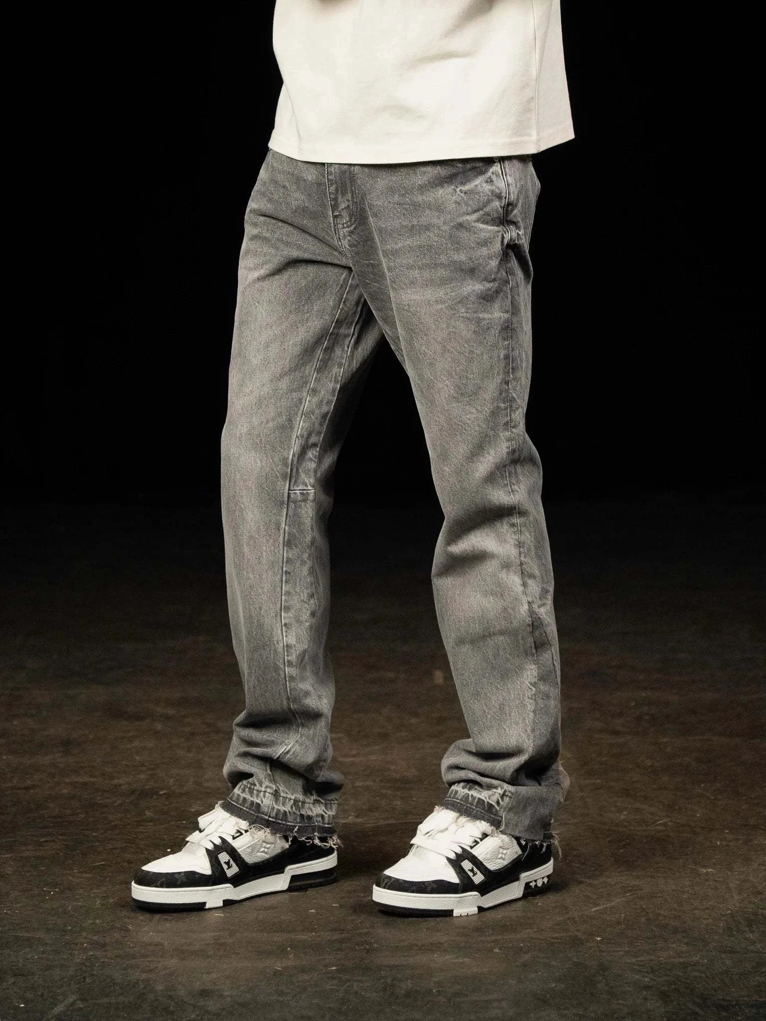 Siarr Flared Jeans Triple Grey with open hem and branded rivet buttons on model