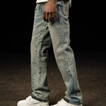 Siarr Flared Jeans in dusty blue denim with open hem and branded rivet buttons