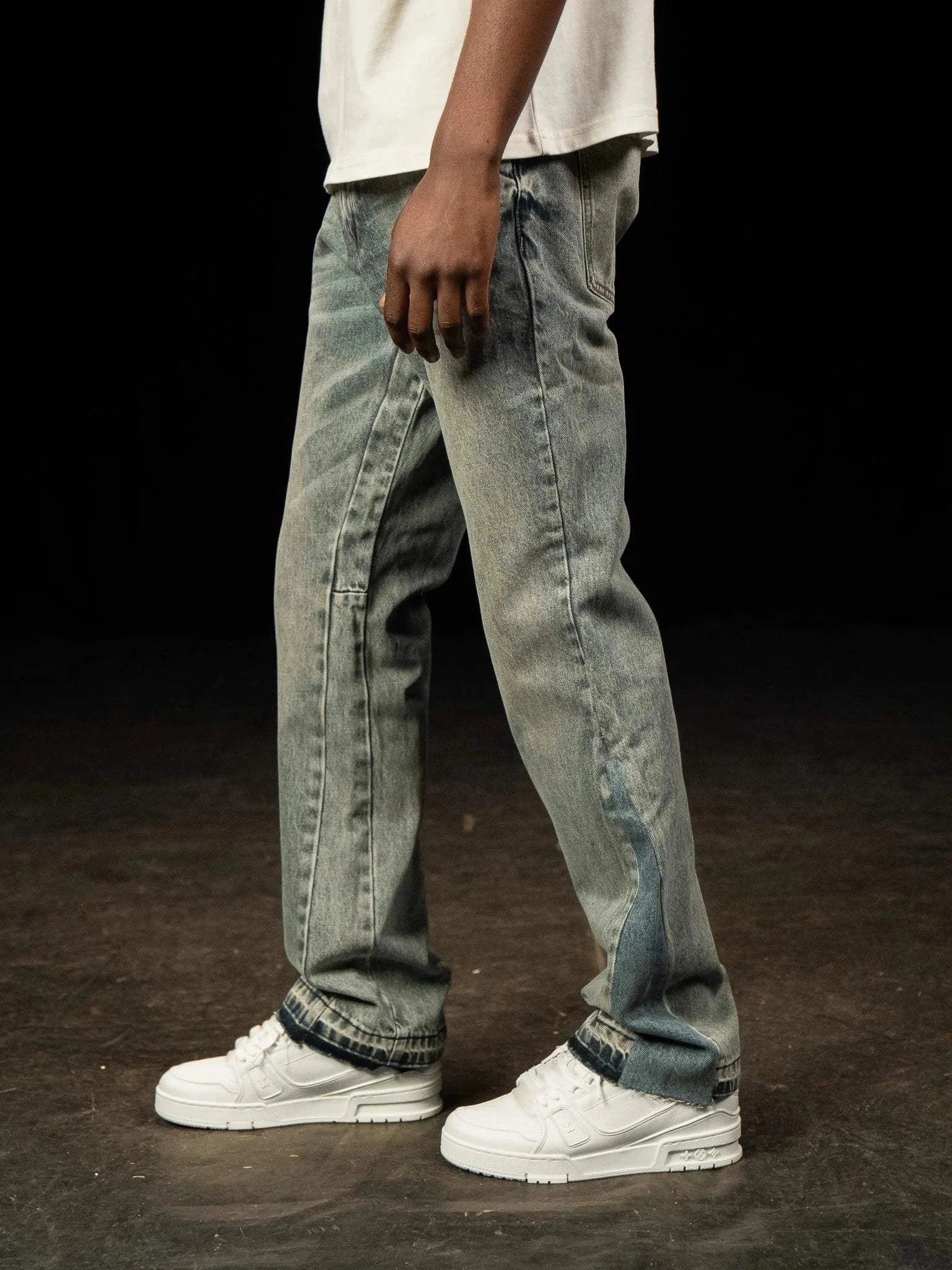 Siarr Flared Jeans in dusty blue denim with open hem and branded rivet buttons