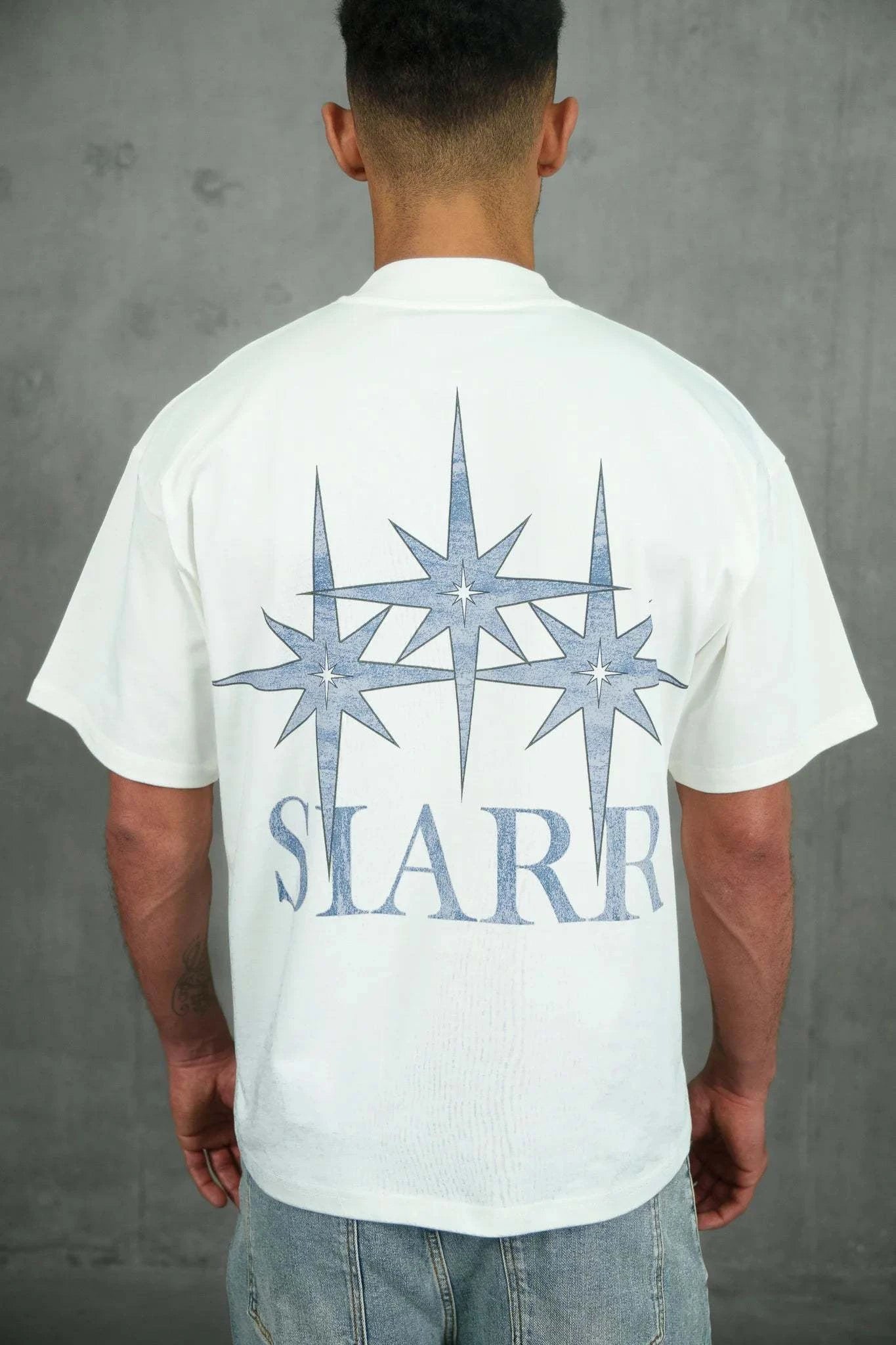 White Siarr Stardust Tee with large back graphic, relaxed fit, ribbed crew neck, and 100% cotton fabric.