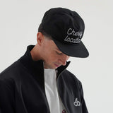 Man wearing Cherry Location black cap with embroidered text and black jacket with cherry logo