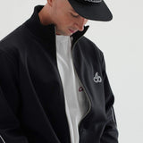 Man wearing Cherry Location Black Tracksuit with zipper and cherry logo on chest