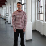 Man wearing Cherry Location OG Stripe T-Shirt with red and white stripes in an indoor setting