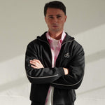 Man wearing Cherry Location black tracksuit zipper with cherry logo and white piping detail