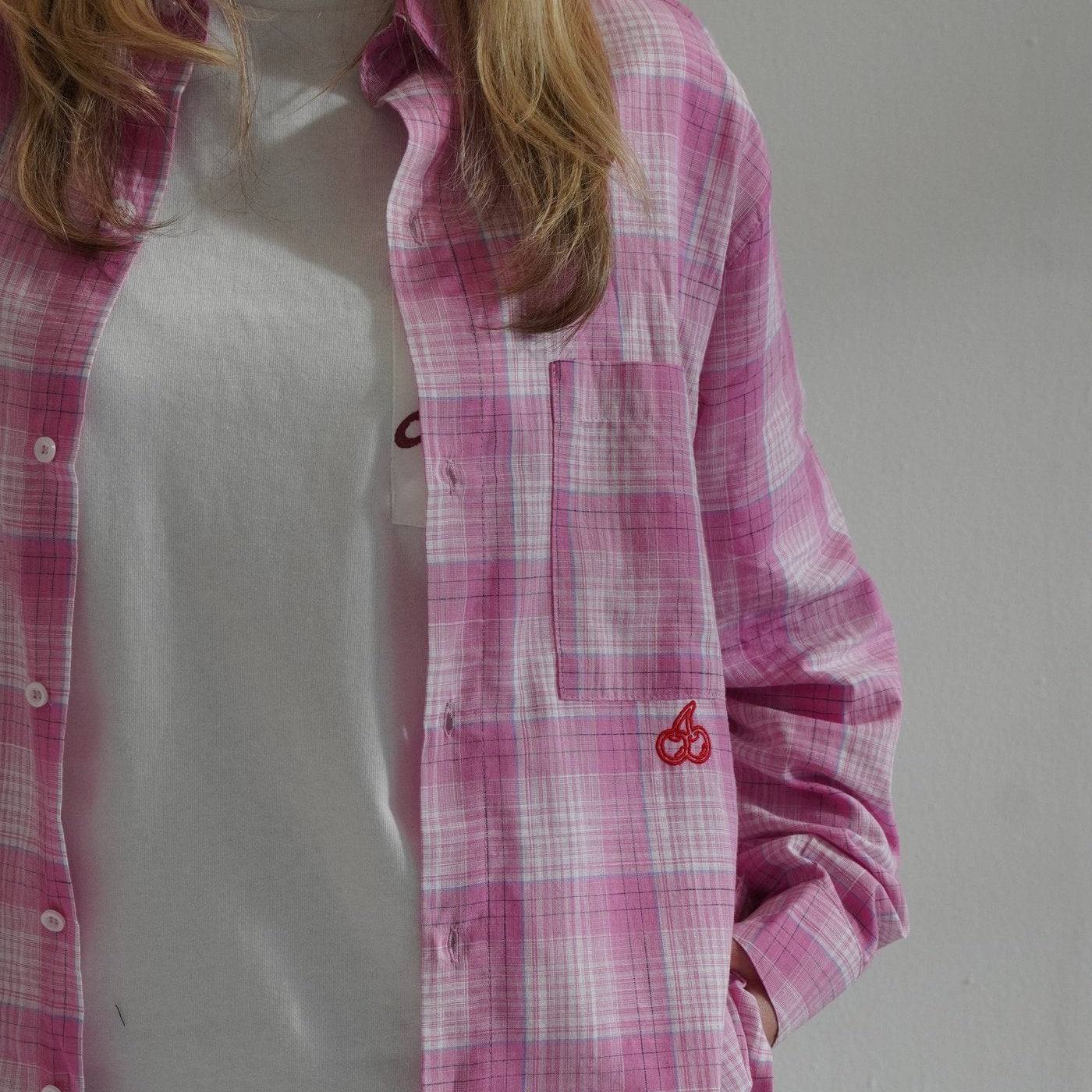 woman wearing Cherry Location Pink Shirt plaid button-up with embroidered cherry detail over white t-shirt