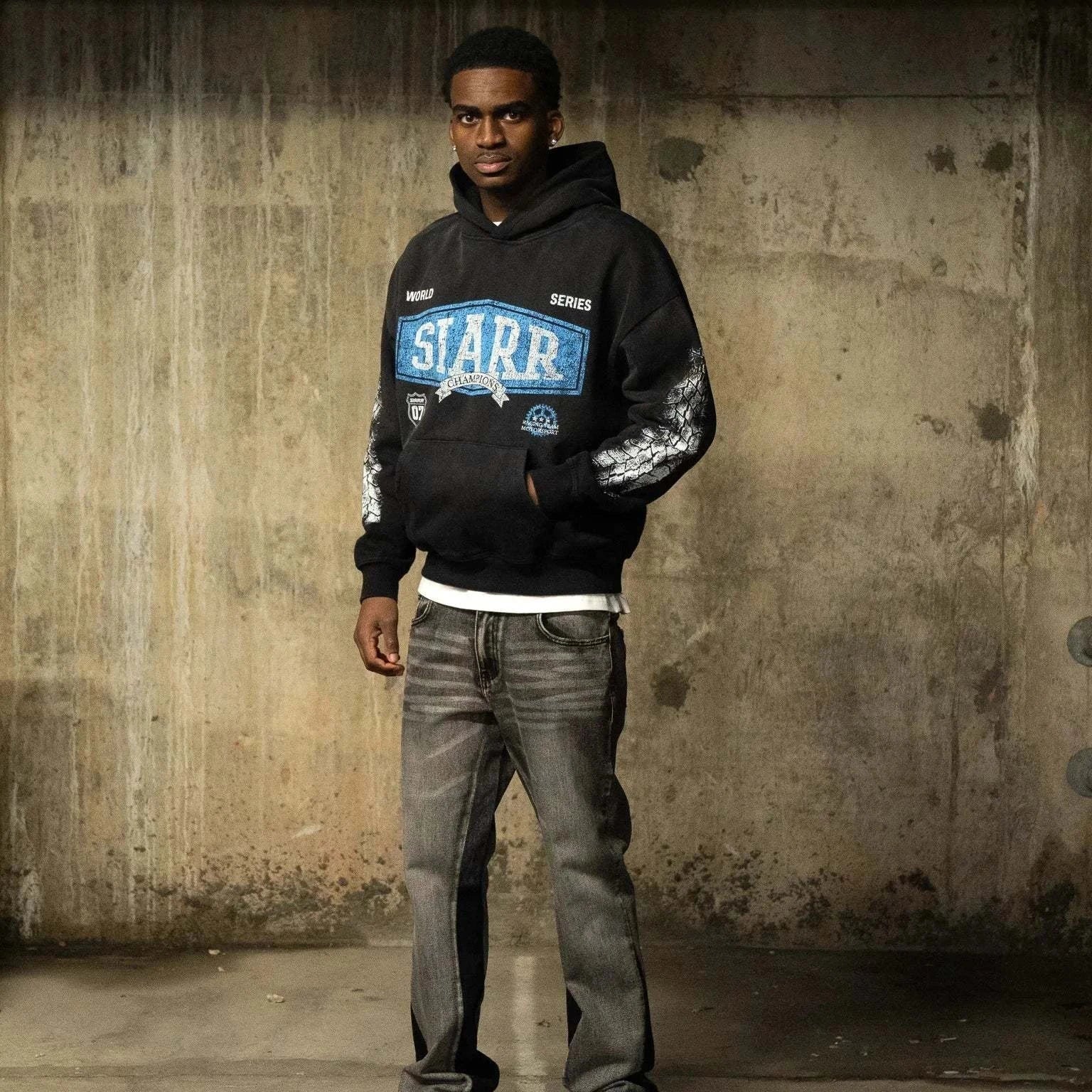 Siarr World Series Hoodie in washed black with pullover hood and kangaroo pocket, 100% cotton regular fit pullover