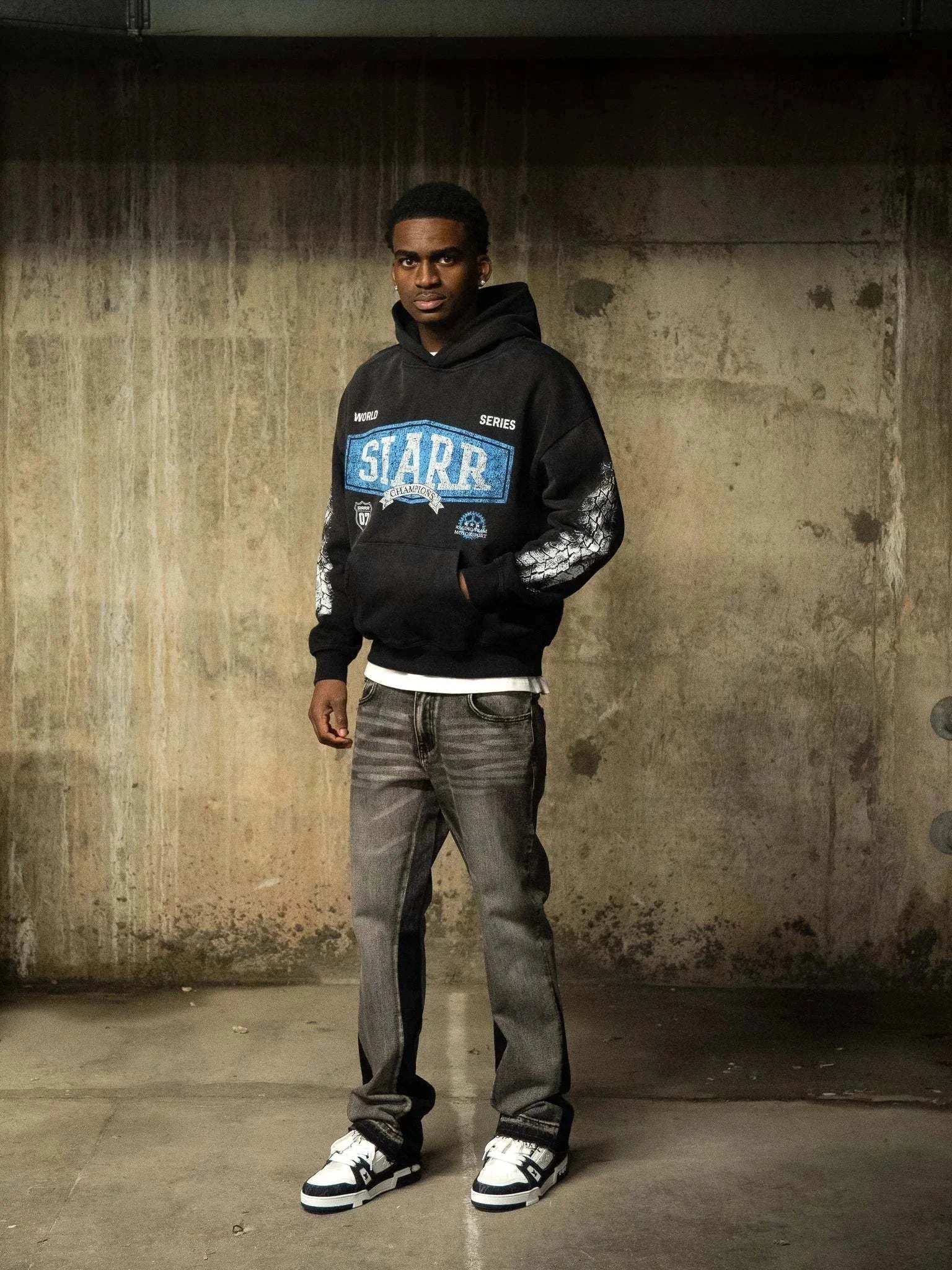 Siarr World Series Hoodie in washed black with pullover hood and kangaroo pocket, 100% cotton regular fit pullover