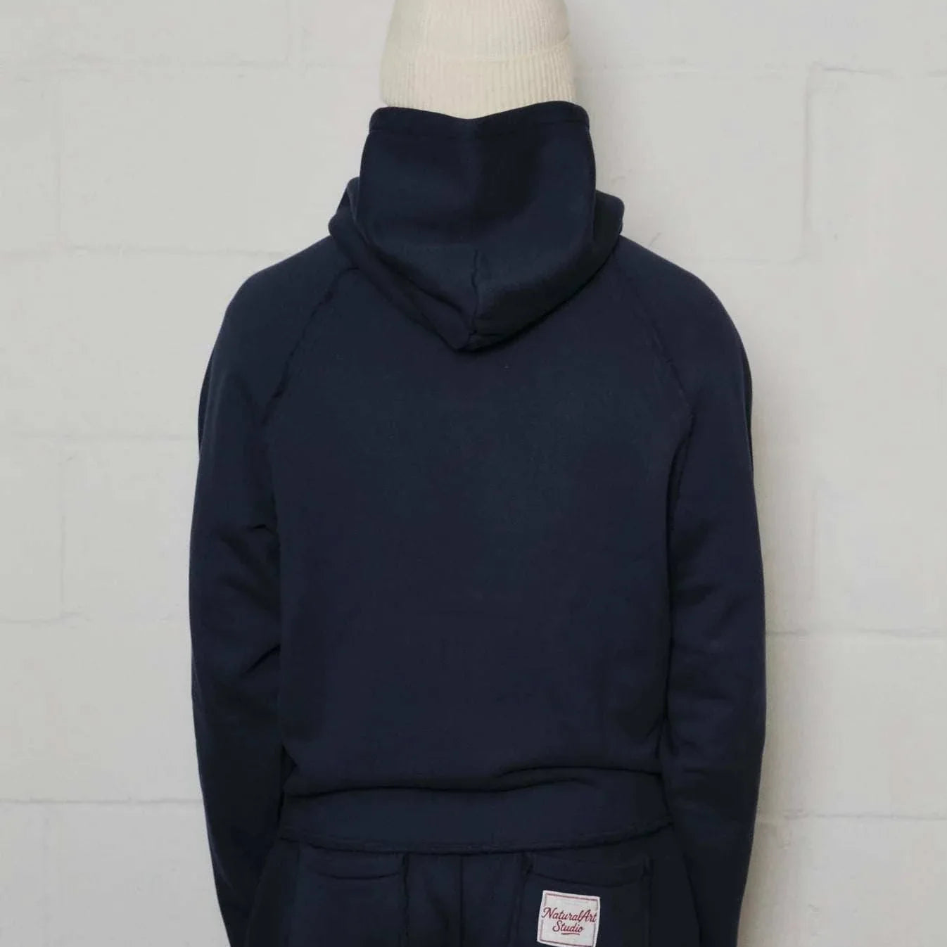 Natural Art Studio navy applique hoodie with raglan seams and woven patch, 100% cotton luxury athletic fit