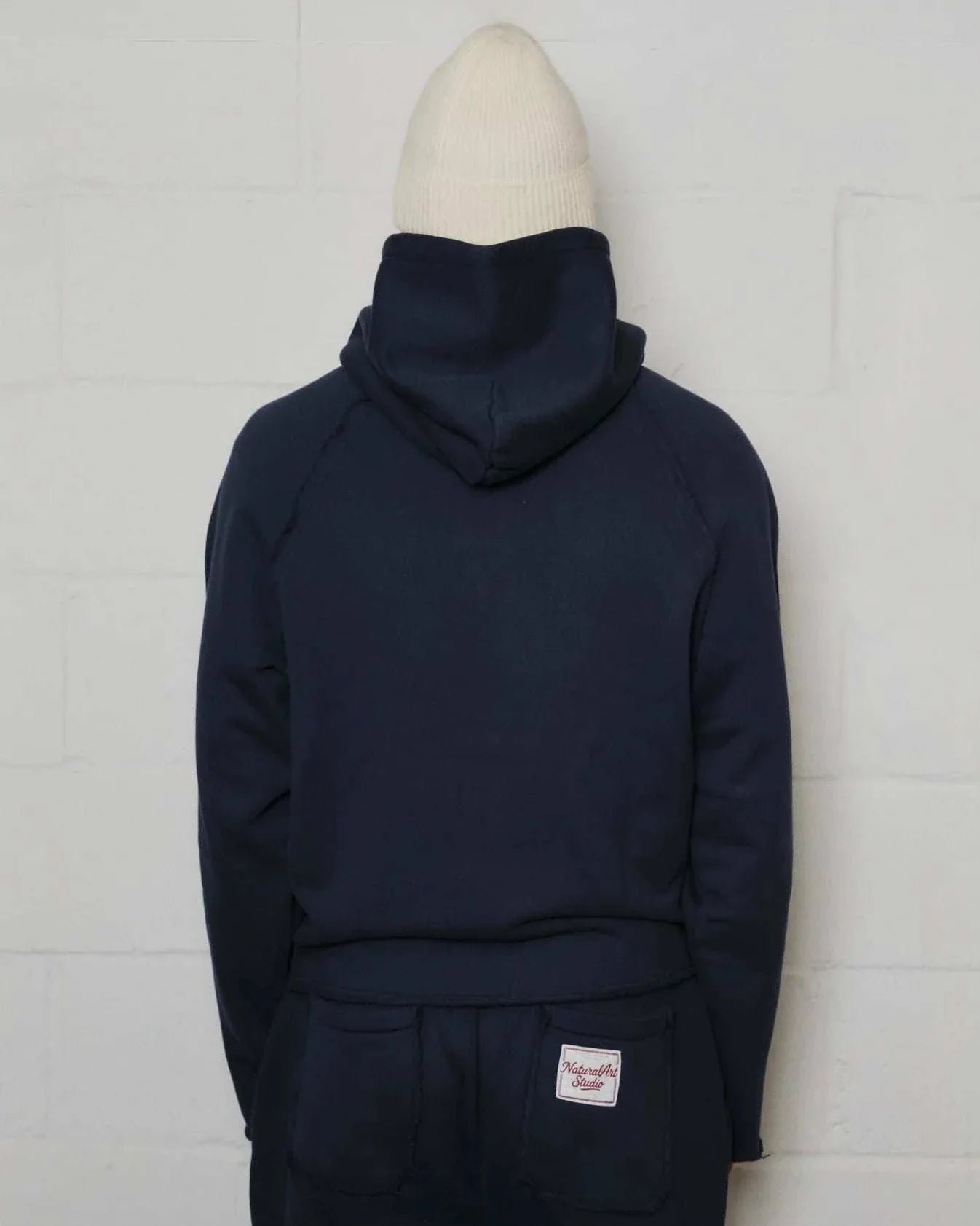 Natural Art Studio navy applique hoodie with raglan seams and woven patch, 100% cotton luxury athletic fit