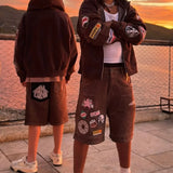 Men wearing Last Lesson Badged Casazøna Shorts with patches at sunset outdoor setting