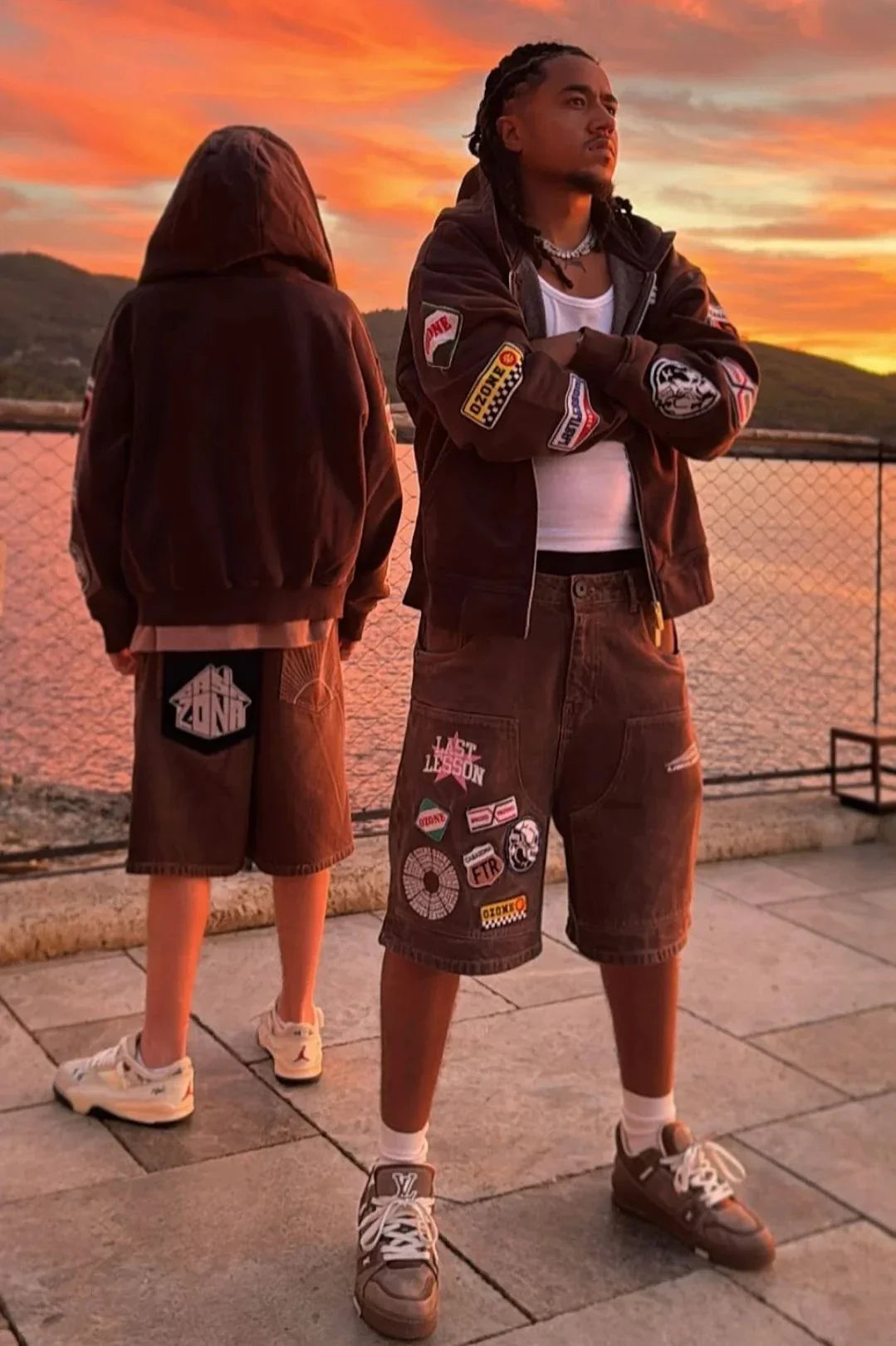 Men wearing Last Lesson Badged Casazøna Shorts with patches at sunset outdoor setting